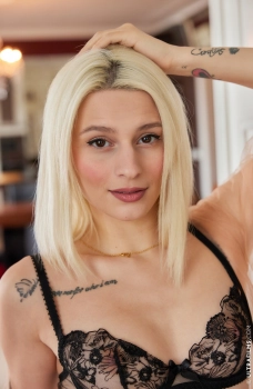 Стройная блондинка с маленькими татуировками на теле